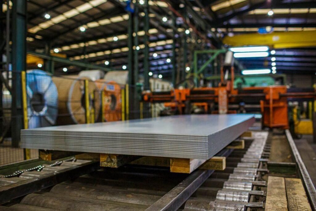 Stack of sheet metal stock on an industrial manufacturing line, ready for fabrication and processing.