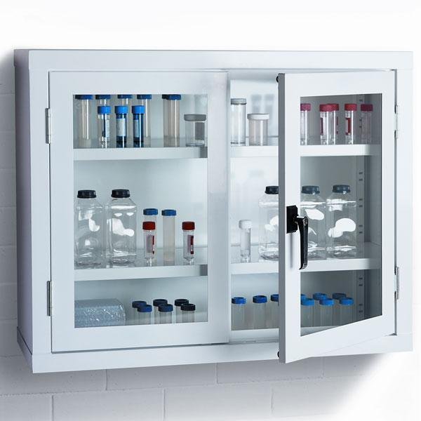 Wall-mounted white sheet metal laboratory storage cabinet with glass doors, internal shelves, and transparent containers for organised laboratory storage.